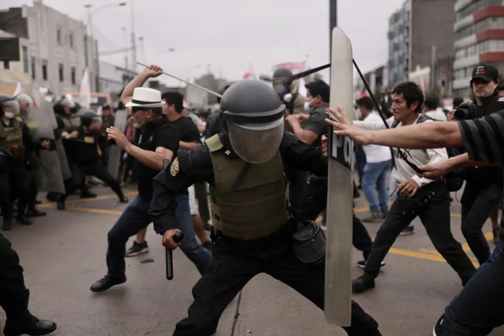 Protesters and police clash in the streets of Lima, Peru.